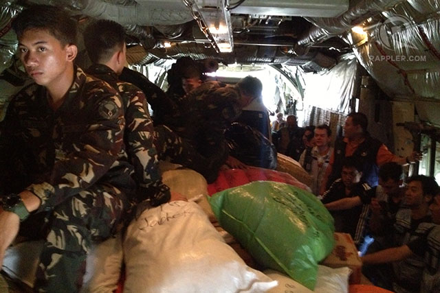 RELIEF EFFORT. Soldiers, UN personnel and DSWD volunteers on board the C130 aircraft en route to Tacloban city. Photo by Rappler/Rupert Ambil