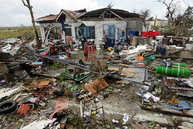 BADLY HIT. A child stands among the debris after typhoon Yolanda/Haiyan devastated the city of Tacloban, Leyte. Photo by EPA/Francis Malasig 