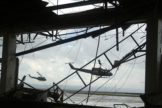 PRIORITY RELIEF. Philippine Air Force helicoper take off from the devastated airport in Tacloban city. Photo by EPA/Francis Malasig