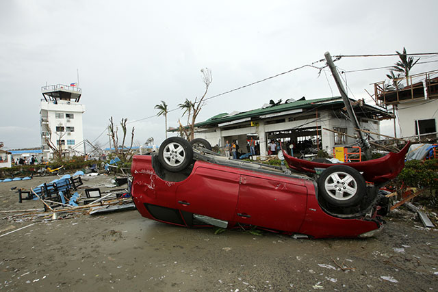 SEVERE DAMAGE. The scene on a street just outside the Tacloban airport. Photo by Francis Malasig/EPA