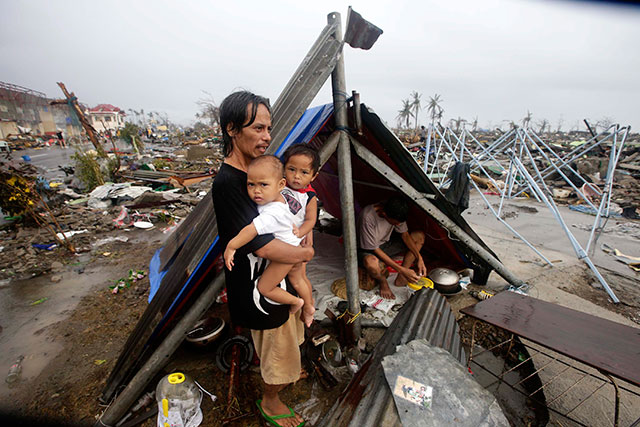 WAITING. Calamity victims wait for food relief outside their makeshift tent in Tacloban city. Photo by EPA/Dennis Sabangan