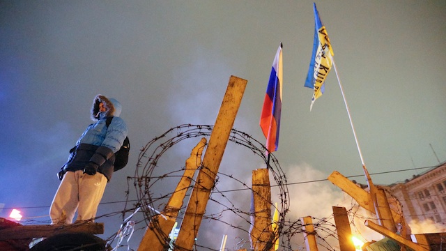 AT THE BARRICADES. A protester stands guard on a barricade around a pro-European protesters tent camp at Independence square in Kiev, Ukraine, 17 January 2014. Sergey Dolzhenko/EPA