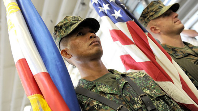 SIDE BY SIDE. US and Philippine Marines carry their respective colors at the formal opening of the annual Philippine-US Amphibious Landing Exercises aboard the USS Bonhomme Richard which docked at the former US naval base of Subic on October 8, 2012. File photo by AFP/Jay Directo
