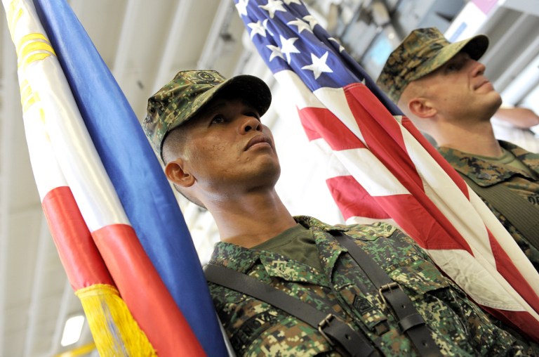 SIDE BY SIDE. US and Philippine Marines carry their respective colors at the formal opening of the annual Philippine-US Amphibious Landing Exercises aboard the USS Bonhomme Richard which docked at the former US naval base of Subic on October 8, 2012. File photo by AFP/Jay Directo
