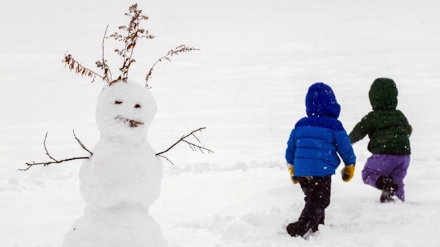 SNOWY HOLIDAYS. Two girls run through past their snowman on December 27, 2012 in Greenfield, Massachusetts. A serious winter storm that caused tornados in the South on Christmas Day swept across the Northeast on Thursday, bringing snow, sleet, rain and causing dangerous travel conditions. Matthew Cavanaugh/Getty Images/AFP