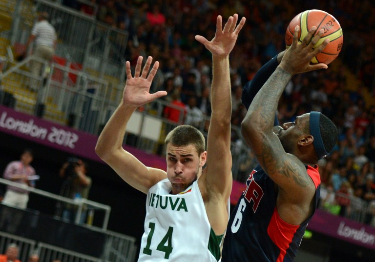 US forward LeBron James (R) vies with Lithuanian centre Jonas Valanciunas during the men's preliminary round group A basketball match Lithuania vs USA of the London 2012 Olympic Games on August 4, 2012 at the basketball arena in London. AFP PHOTO / POOL / TIMOTHY A. CLARY