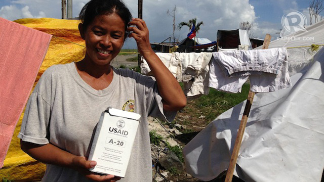 RELIEF. Typhoon victim Amelia Alcain shows ready-to-eat meal distributed by USAID. Photo by Voltaire Tupaz