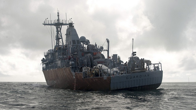 SITTING ON THE REEF. Led by US Navy Supervisor of Salvage Capt Mark Matthews, an experienced team of salvage professionals are ready to dismantle the 23-year-old minesweeper and safely remove the ship from the reef. February 8 photo courtesy of US Navy