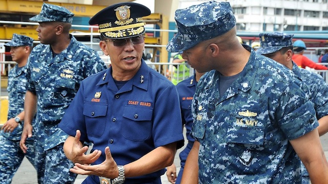 Rear Admiral Cecil R. Chen (L), commander of Philippine Coast Guard District National Capital Region - Central Luzon, speaks with Cmdr. Thomas “T.J.” Dixon, commanding officer of the Arleigh Burke-class guided-missile destroyer USS McCampbell (DDG 85). Photo courtesy of US Embassy in Manila