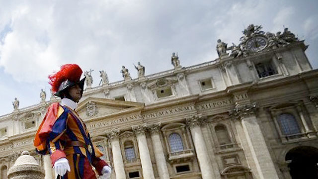 HEADACHE. A Swiss guard walks outside the St Peter's Basilica in this file photo