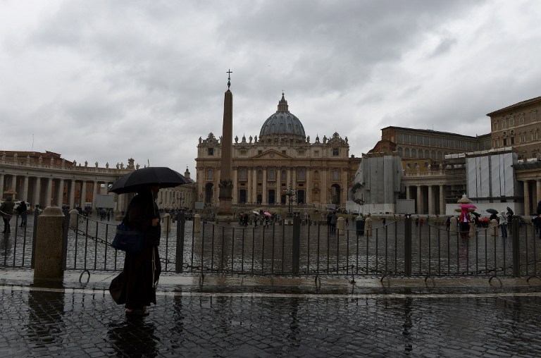 A monk walks on St Peter's square on March 6, 2013 at the Vatican. AFP PHOTO / VINCENZO PINTO