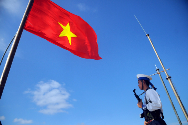 'BRAVE, PATRIOTIC.' A picture made available on June 9, 2014 shows a Vietnamese naval soldier standing guard next to a Vietnamese flag on Thuyen Chai Island, one of the Spratly Islands, on January 17, 2013. Photo by STR/EPA