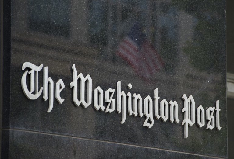 IN TRANSITION. A sign hangs on the outside of the Washington Post Building August 6, 2013 in Washington, DC. AFP/Saul Loeb