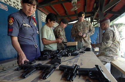 US and Filipino officials inspect weapons before a funshot competition in General Santos. Photo by Cocoy Sexcion