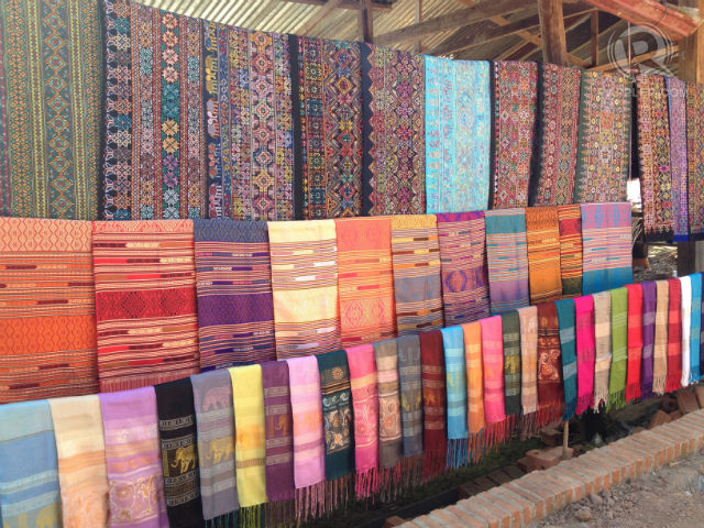 CULTURAL THREADS. Laos traditional textile on display at a village stall. All photos by Zak Yuson