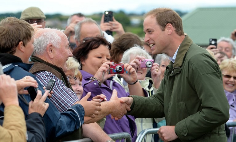 GREETING THE CROWD. Britain's Prince William (R) meets members of the public as he visits the Anglesey Show in North Wales on August 14, 2013. Photo by AFP / Andrew Yates / Pool