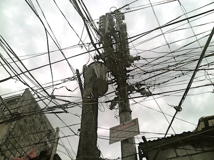 ENTANGLED. A mesh of electric wires mirrors the quality of life of residents of Paradise Village. Photo by Nikki Luna