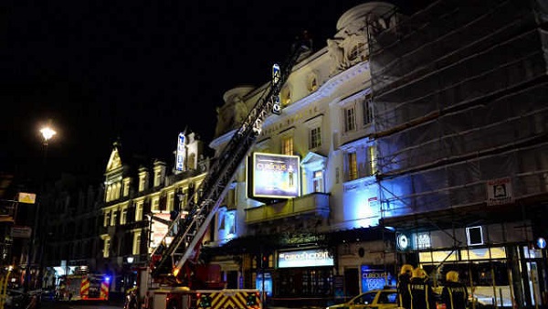 COLLAPSE. Emergency services personnel use a hydraulic lift to investigate the cause of a ceiling collapse at a theater in Central London. LEON NEAL/AFP PHOTO
