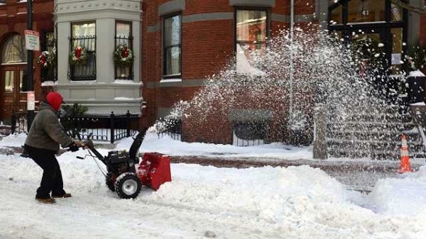 SNOWY DAY. A man snow blows on East Concord Street in the South End after a two day winter storm January 4, 2014 in Boston, Massachusetts. Darren McCollester/Getty Images/AFP