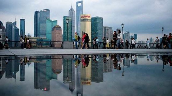 WEALTH. Asians to be world's richest, a study shows. File photo of pedestrians walking past Shanghai skyline by AFP