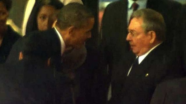 SYMBOLIC HANDSHAKE. President Barack Obama shakes hands with Cuban leader Raul Castro at Mandela's memorial. AFP screengrab from South African Broadcasting Corporation live feed show