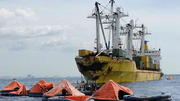 AFTERMATH. Life rafts from the sunken ferry St. Thomas Aquinas float in front of cargo ship Sulpicio Express 7 on August 17, 2013, whose bow was destroyed after a colliding with the ferry the night before off Talisay, Cebu. Photo by AFP/Ted Aljibe