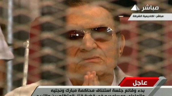 HOSNI MUBARAK. An image grab taken from Egyptian state TV shows ousted Egyptian president Hosni Mubarak gesturing behind bars during a hearing in his retrial at the police academy in Cairo on July 6, 2013. While Mubarak has been granted conditional release in one of the corruption cases against him, an additional corruption case kept him in custody until August 21, 2013. Photo by AFP/Egyptian TV 