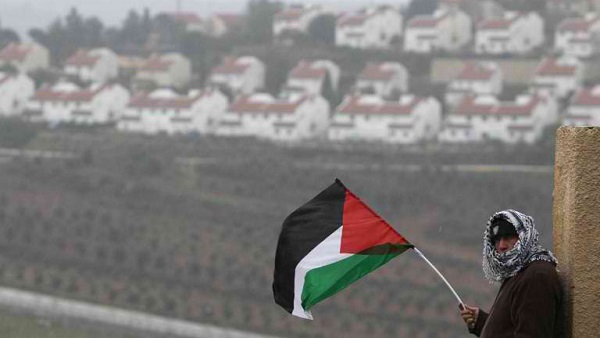 LONGING FOR PEACE. In this file photo, a Palestinian man waves his national flag on the sidelines of a march organized by inhabitants of the West Bank village Nabi Saleh on December 21, 2012, to protest against the expansion of Jewish settlements on Palestinian land. AFP/Abbas Momani