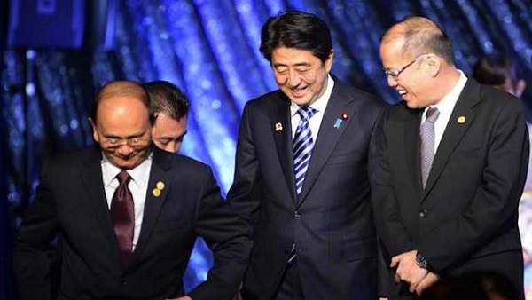 apanese Prime Minister Shinzo Abe (C) smiles with Myanmar's President Thein Sein (L) and Philippine President Benigno Aquino III (R) leaving the stage during a gala dinner of the ASEAN-Japan commemorative summit meeting hosted by Japanese prime minister in Tokyo on December 14, 2013. AFP PHOTO / POOL / TOSHIFUMI KITAMURA