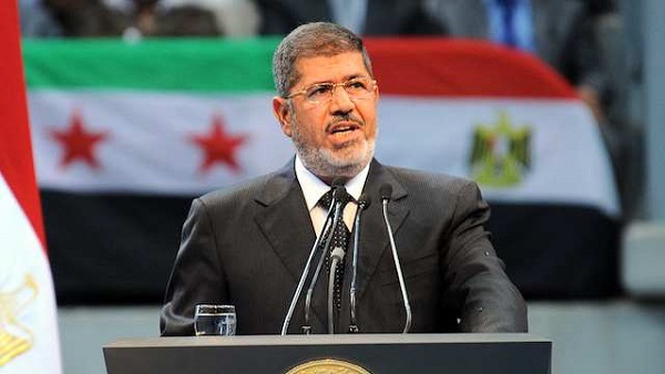 A handout photograph released by the Egyptian Presidency shows Egyptian President Mohamed Morsi talking to his supporters as he attends a Syria solidarity conference organized by the Muslim Brotherhood, Cairo, Egypt, 15 June 2013. Photo courtesy of the Egyptian Presidency/EPA