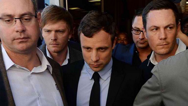 FACING TRIAL. South African Olympic sprinter Oscar Pistorius (C) leaves the Magistrate Court in Pretoria on August 19, 2013. Pistorius will go trial in March charged with murdering his girlfriend on Valentine's Day, a magistrate ruled at a packed court hearing on August 19, 2013. Photo by AFP/Alexander Joe