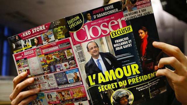 LE 'SCANDAL.' A man reads French magazine Closer, on January 10, 2014 in Paris. Thomas Coes/AFP