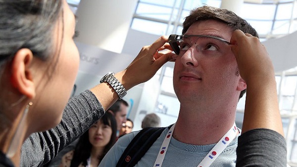 UNITED STATES, San Francisco : SAN FRANCISCO, CA - MAY 17: An attendee is fitted with Google Glass during the Google I/O developer conference on May 17, 2013 in San Francisco, California. Eight members of the Congressional Bi-Partisan Privacy Caucus sent a letter to Google co-founder and CEO Larry Page seeking answers to privacy questions and concerns surrounding Google's photo and video-equipped glasses called 