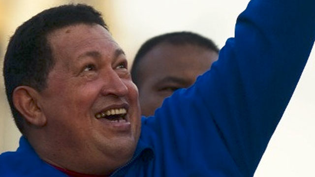 SWORN IN FROM CUBA? Venezuelan President Hugo Chavez greets supporters during a campaign rally in Monagas on September 28, 2012. AFP PHOTO/JUAN BARRETO