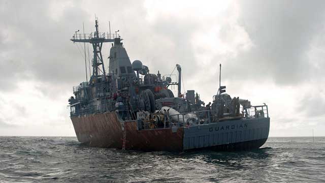 SITTING ON THE REEF. Led by US Navy Supervisor of Salvage Capt Mark Matthews, an experienced team of salvage professionals are ready to dismantle the 23-year-old minesweeper and safely remove the ship from the reef. February 8 photo courtesy of US Navy