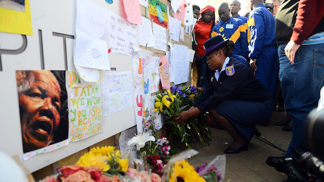 FOR MADIBA. South African Police Services trainees bring flowers and messages of support at the entrance to the Medi-Clinic Heart Hospital in Pretoria, Gauteng, South Africa, 25 June 2013 where former president Nelson Mandela is believed to be undergoing treatment for a recurring lung infection. EPA/STRINGER