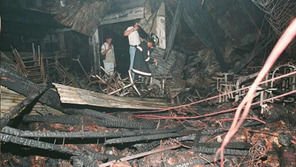 INFERNO. Firefighters and investigators inspect the debris-strewn dance floor following a deadly fire which turned the packed Ozone Disco into an inferno, killing about 150 teenagers in 1996. AFP Photo