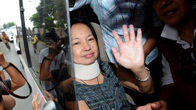 TEMPORARY RELEASE? Arroyo waves at supporters upon arriving home in Katipunan, Quezon City. AFP Photo