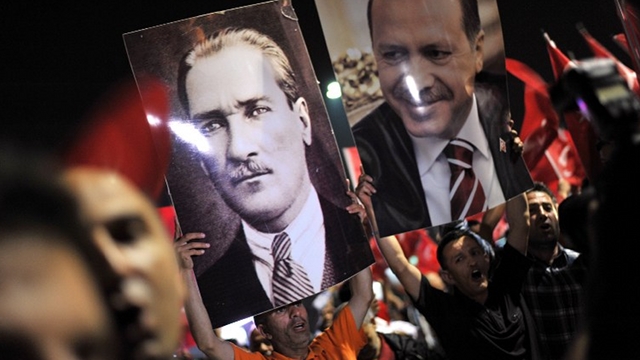WELCOME BACK. Supporters of the Turkish Prime Minister Recep Tayyip Erdogan hold a poster with his picture (R) and that of Mustafa Kemal Ataturk, the founder of modern day Turkey, at Ataturk International Airport in Istanbul on June 6, 2013. AFP/Ozan Kose
