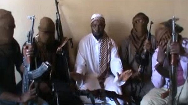 NIGERIA, UNKNOWN : A screengrab taken from a video released on You Tube on April 12, 2012 apparently shows Boko Haram leader Abubakar Shekau (C) sitting flanked by militants. The suspected leader of Nigerian Islamist group Boko Haram appeared in a video posted on YouTube today in which he sends a message to President Goodluck Jonathan and vows to fight on. The 14-minute clip is however mild compared to previous messages from Abubakar Shekau, the alleged leader of the main branch of the group blamed for scores of shootings and bombings, mostly in Nigeria's mainly Muslim north. RESTRICTED TO EDITORIAL USE - MANDATORY CREDIT 