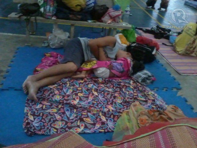 FATHER AND CHILD. Evacuees rest at Xavier University-Ateneo de Cagayan in Cagayan de Oro City. Photo by Sam Macagba