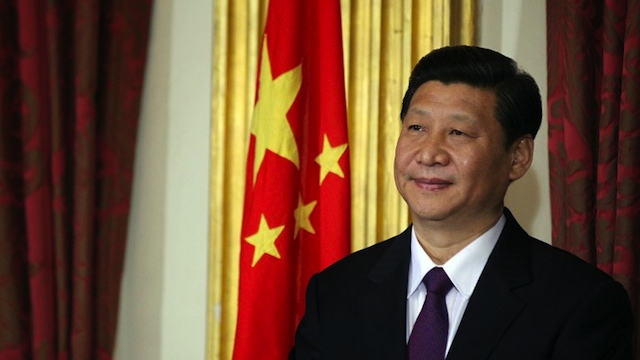 MYSTERY MAN.  Chinese Vice President Xi Jinping smiles after signing multiple trade deals in the State Room in Dublin Castle Dublin, Ireland on February 19, 2012. AFP PHOTO/ PETER MUHLY