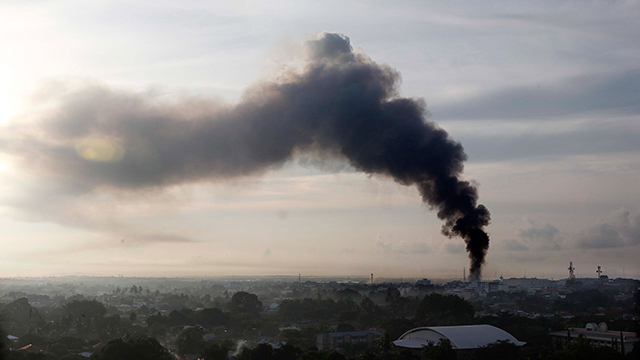 MORE GUNBATTLES. A smoke billows from the site of renewed clashes in Zamboanga City, September 16, 2013. Photo by Dennis Sabangan/EPA