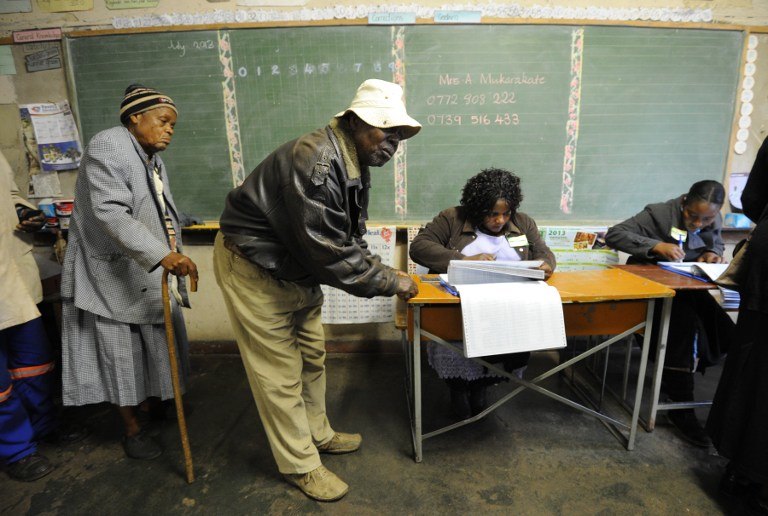 Zimbabweans arrive to vote at a polling booth in a school in Harare on July 31, 2013. Photo by AFP/ Alexander Joe