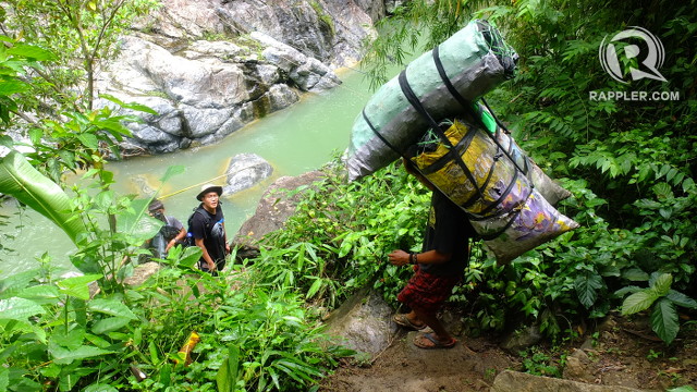 ULINGAN. A local carries bags of charcoal, a product obtained by burning forests, down the forests in the Ipo watershed. Photo by Pia Ranada/Rappler