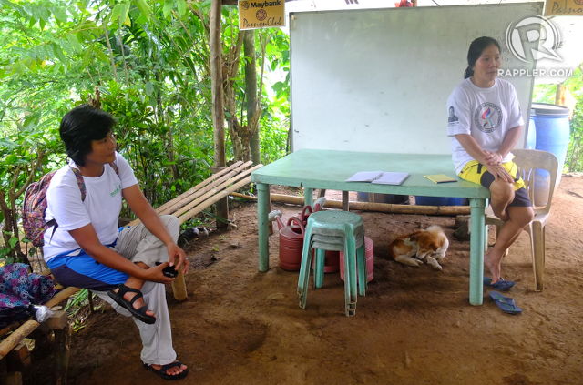 COMMUNITY-BASED REFORESTATION. Forester Tess Argota and village organization president Virginia Banaga in the village office in Calawis where they keep the seedling nursery