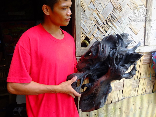 DRIFTWOOD ART. Joselito, a Dumagat, holds a piece of driftwood art