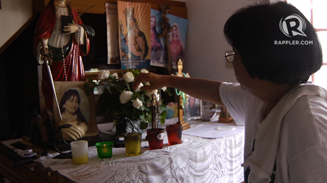 WAITING FOR IRENE. Malen Pabellon, Irene Gunawan's sister-in-law places new flowers beside an old picture of her. All photos by Franz Lopez/Rappler
