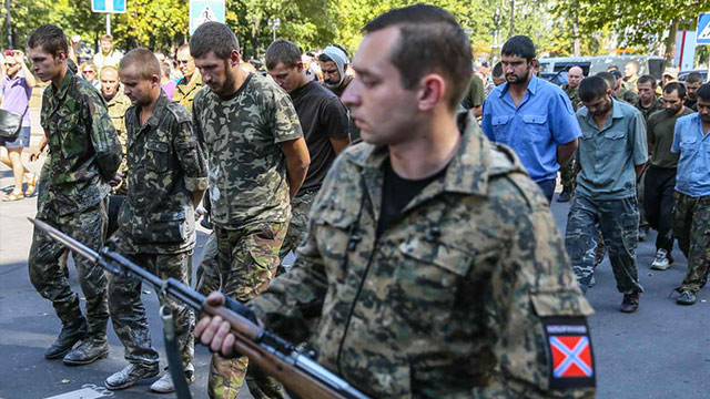 PARADED. The military personnel of the self-proclaimed Donetsk People's Republic escort Ukrainian army prisoners of war in downtown of Donetsk, Ukraine, 24 August 2014