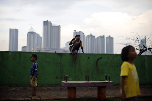 MORE PARKS. Children play at a public park in Jakarta as high rise buildings are seen on the background. File photo by EPA 